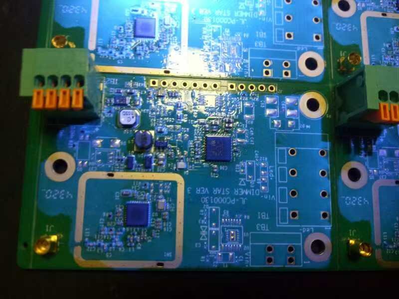 A close-up of a PCBA with conformal coating applied