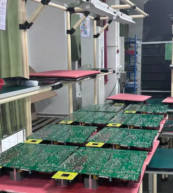 Bottom-side view of industrial and commercial energy storage inverter PCBs staged for batch processing in production, showing assembled boards with dense solder joints and high-power inverter board construction.