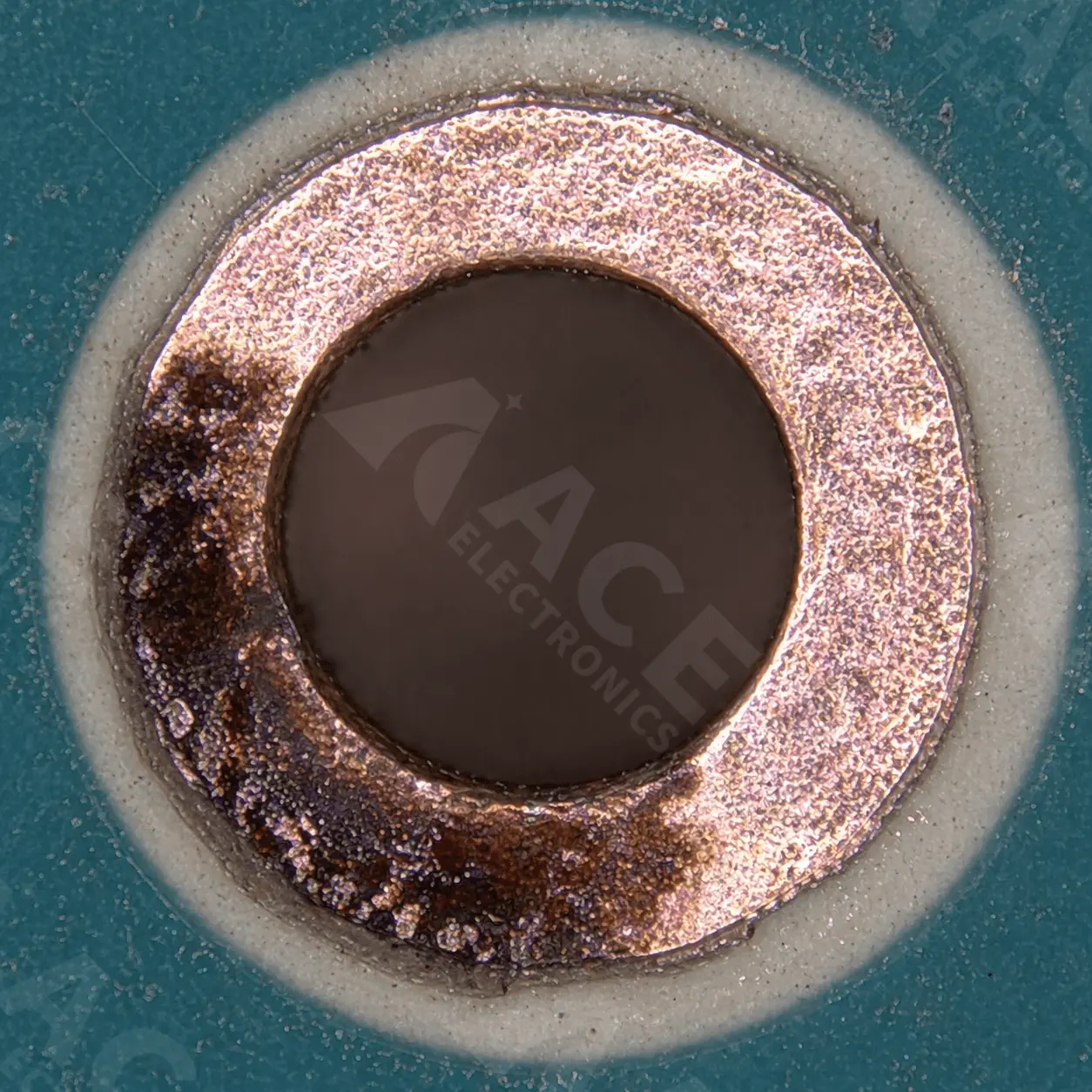 ENIG black pad defect showing nickel corrosion on a PCB via annular ring under high-magnification microscope