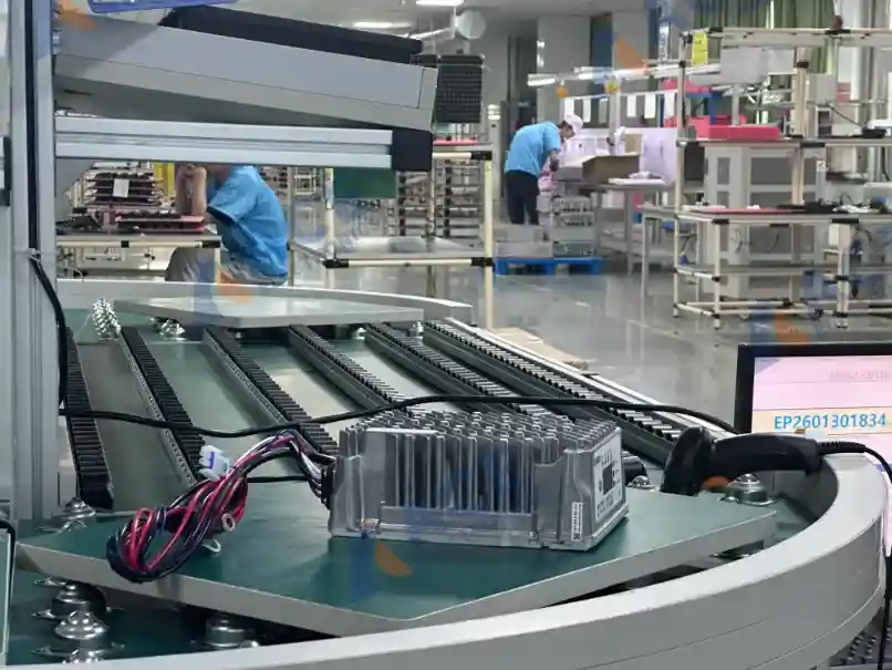 Assembled energy storage device moving through the production line after aluminum enclosure assembly